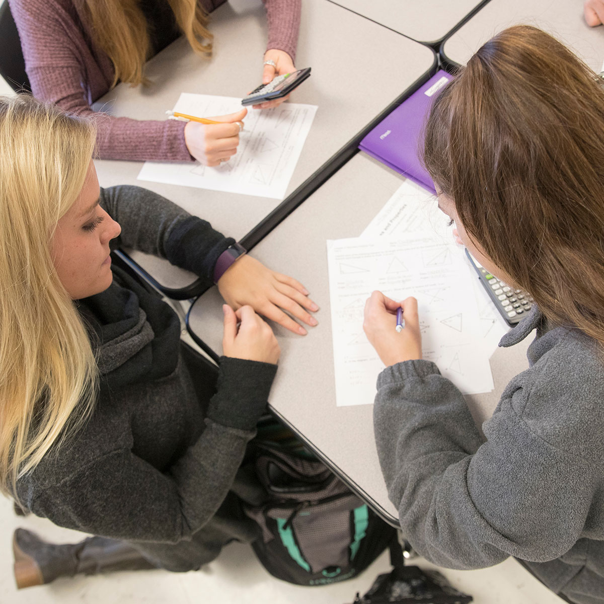 Student-teacher Sara Jones gives guidance to a student doing math work at Willard High School.