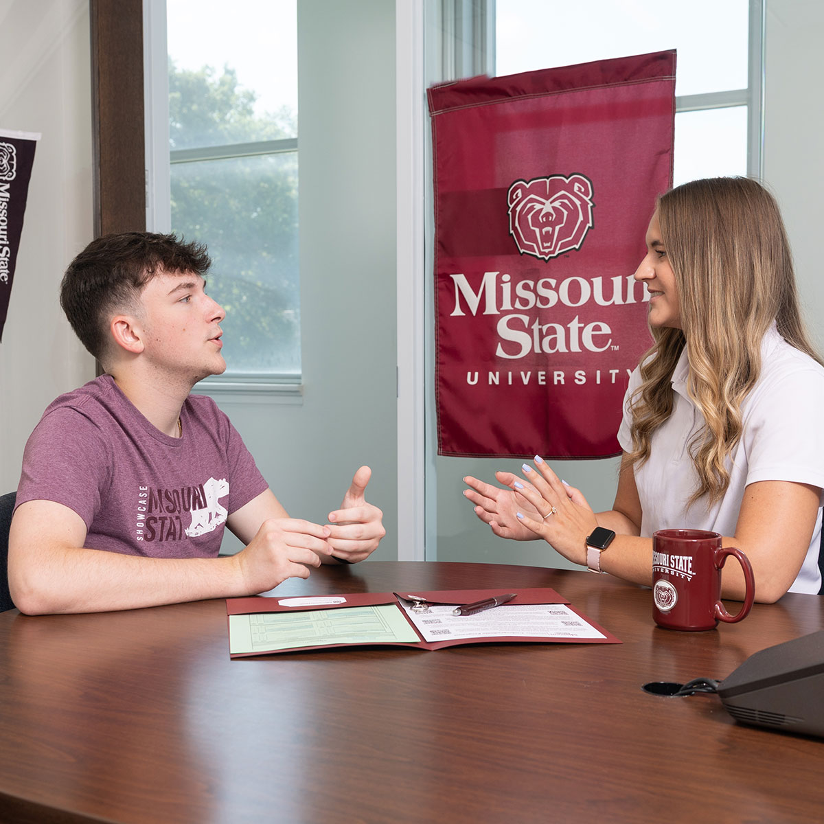 A new student asks questions about the admissions process to a Missouri State employee.