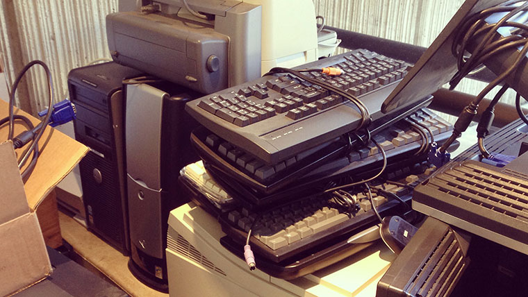Stacks of old electronics ready for recycling.