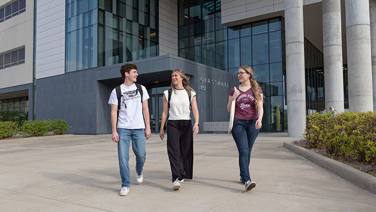Three Missouri State students walking from Glass Hall.