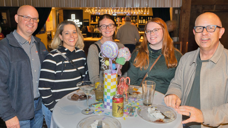 Five individuals attending the Foundation holiday reception.