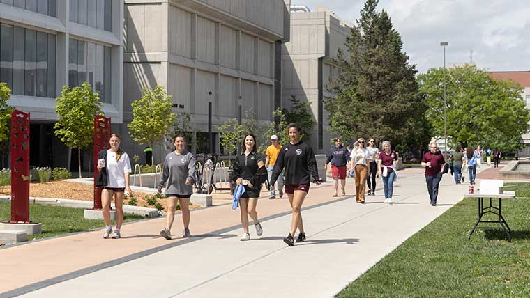 Missouri State students walking during a sunny day on campus.