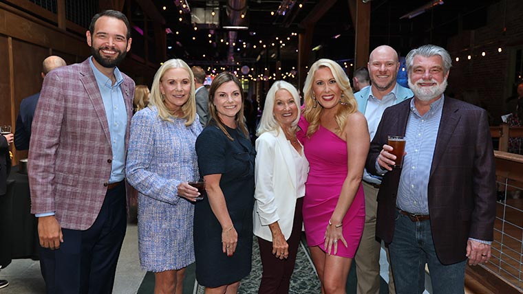 A group photo of attendees at the Founders Club reception.