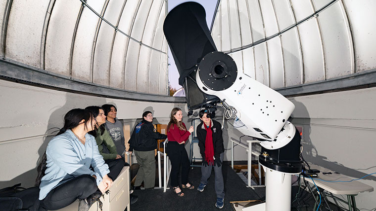 Missouri State students looking through the telescope at William G. and Retha Stone Baker Observatory.