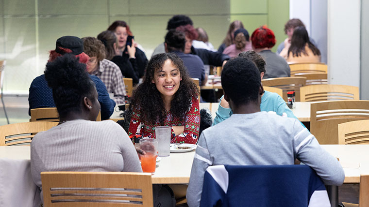 Smiling Missouri State student sitting at a table of four. 