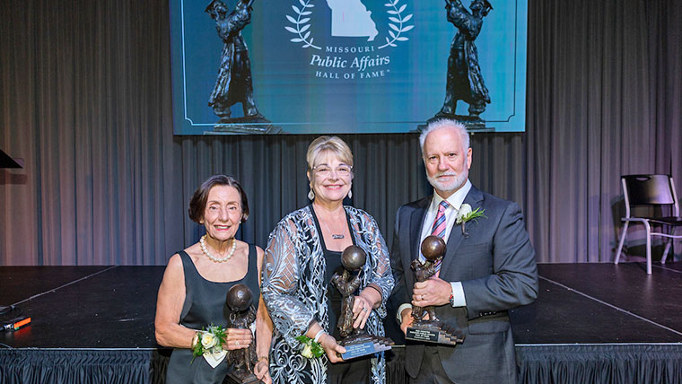 Three recipients holding their awards