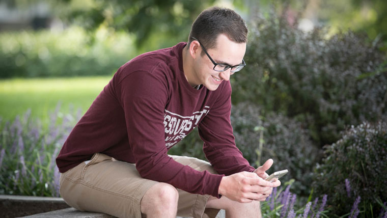 Student using phone.