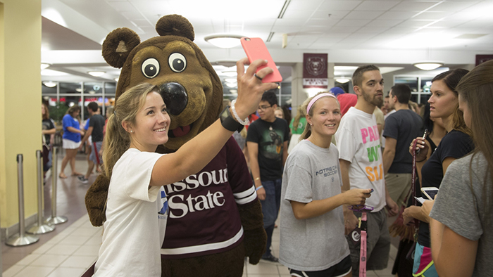 Student taking a selfie with Boomer