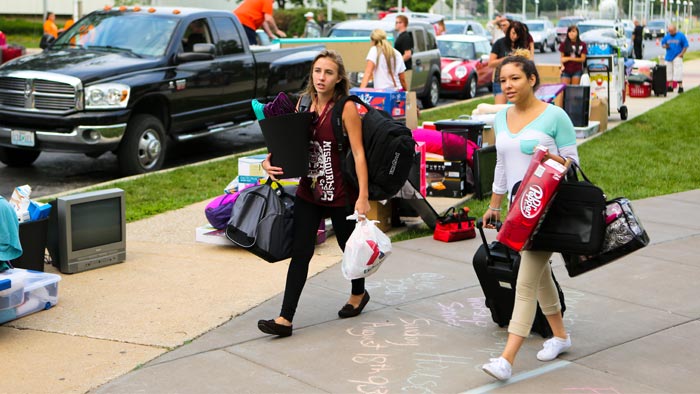 Students carrying their stuff on move-in day