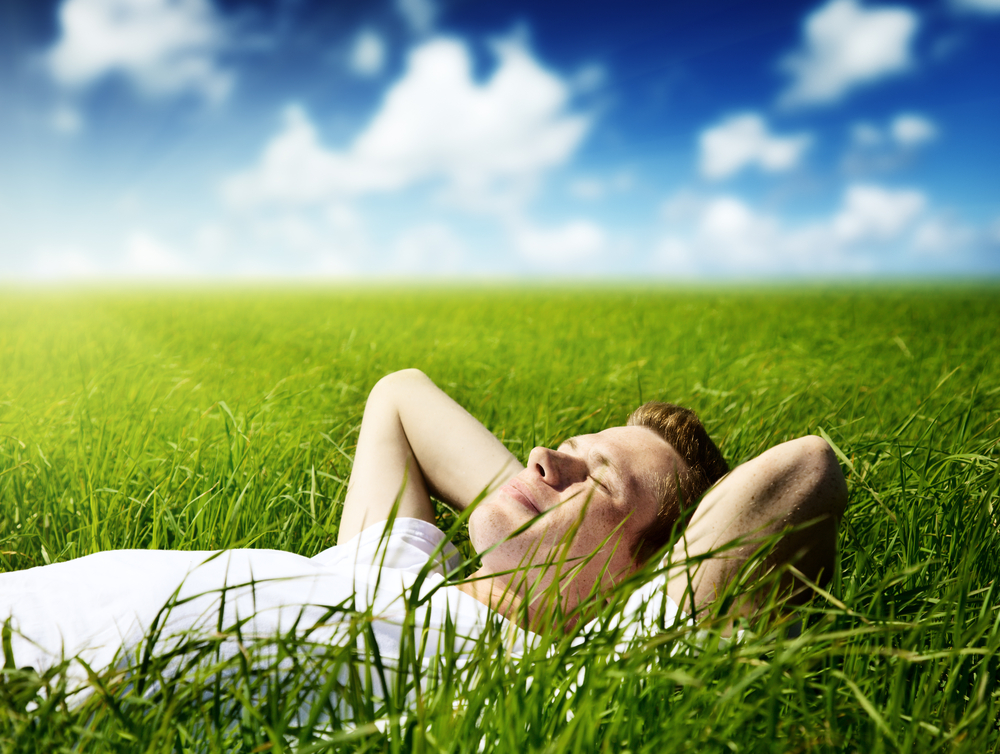 man relaxing in field