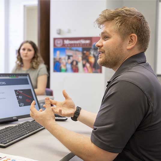 Dr. Jordan Belisle, associate professor of psychology at Missouri State, and a graduate student discuss the HUB research lab.