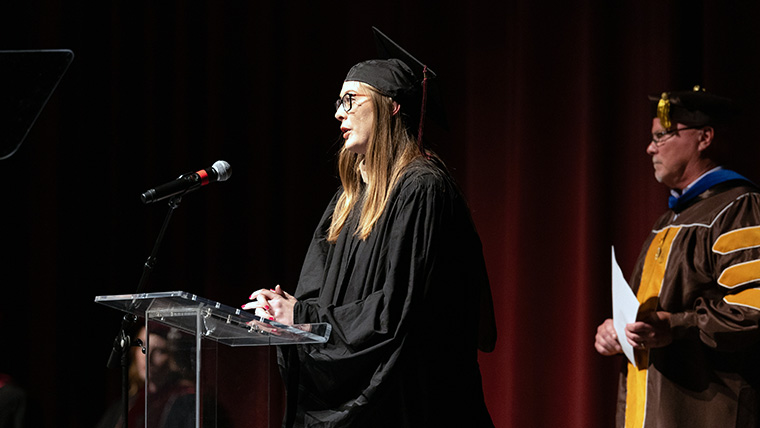 Senate staff member, Campbell Keele, standing at the podium delivering a speech.