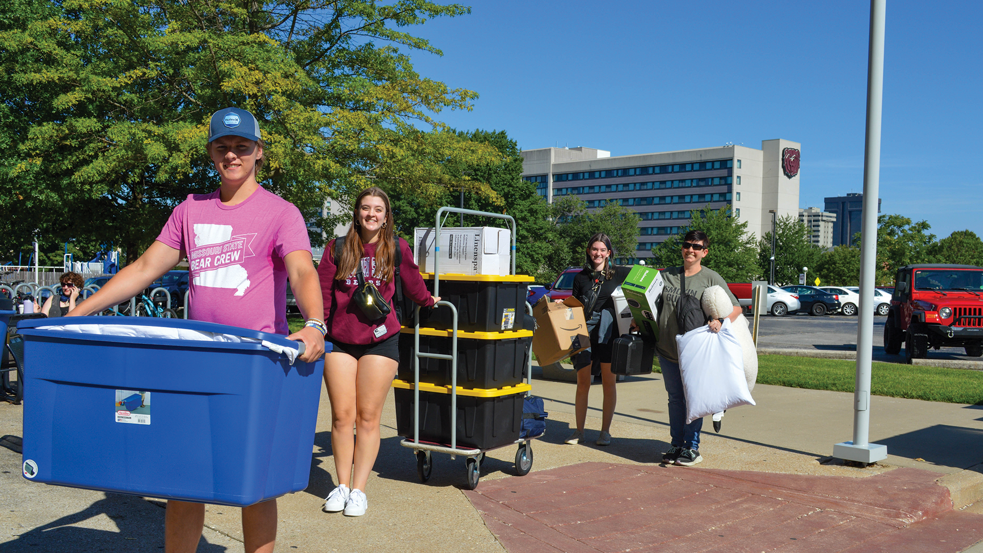 Missouri State students carrying totes while moving on campus.