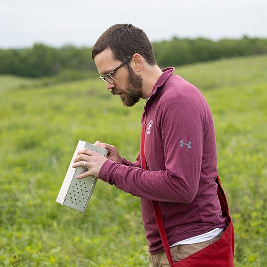 Dr. Sean Maher, associate biology professor at Missouri State University, collecting samples during a field study on mice.