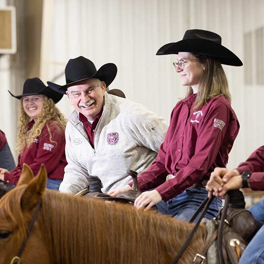 Dr. Gary Webb, department head of animal science at Missouri State University, and two students on horseback.