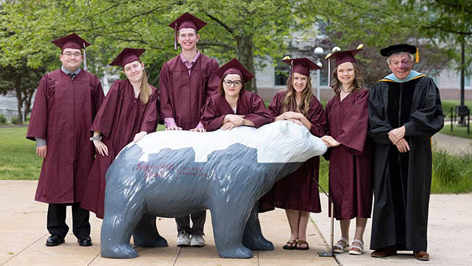 A cohort of Bear POWER graduates stand on campus with Dr Christopher Craig