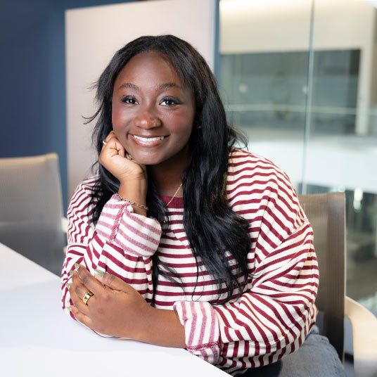 Kamryn Middleton, a freshman double majoring in entrepreneurship and finance at Missouri State, relaxes against a conference room table in Glass Hall.