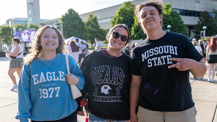 Three students take a photo together at the 2025 Party in the CUSA event, now known as Boomer's Block Party.